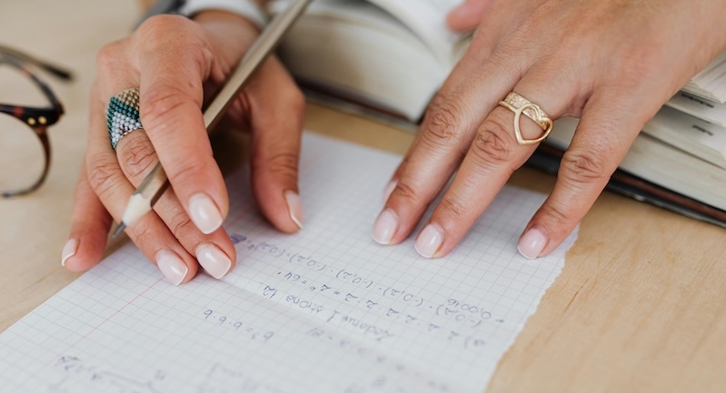 Woman doing the math on her coach training investment
