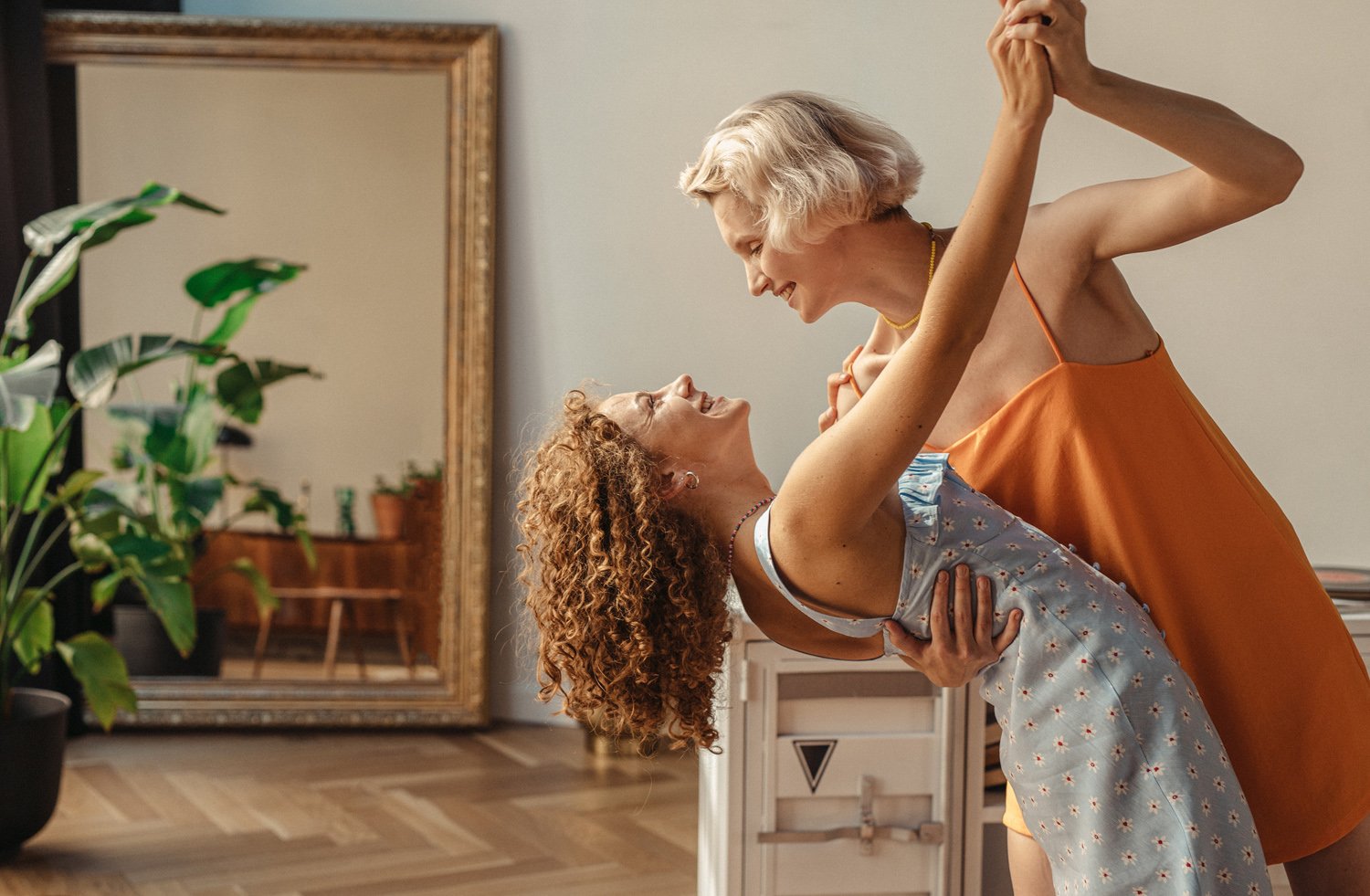 Two women dancing after being certified as relationship coach