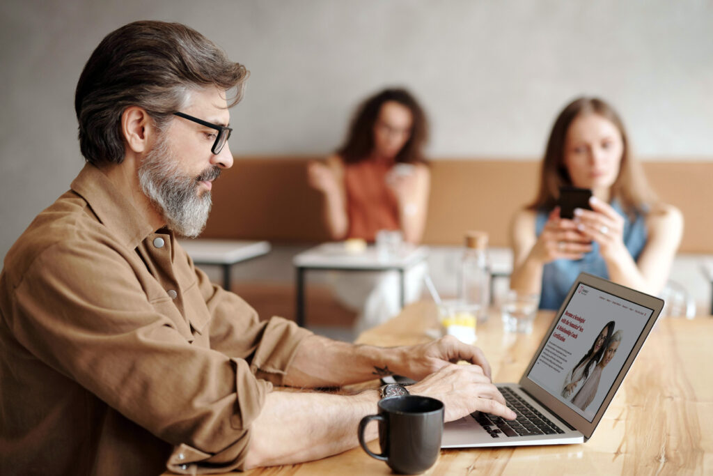 Man working on his coaching business website