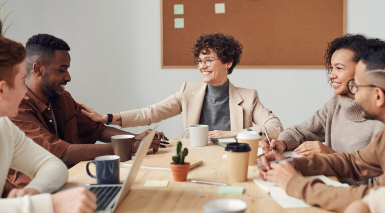 Woman showing emotional intelligence leadership skills in a business meeting