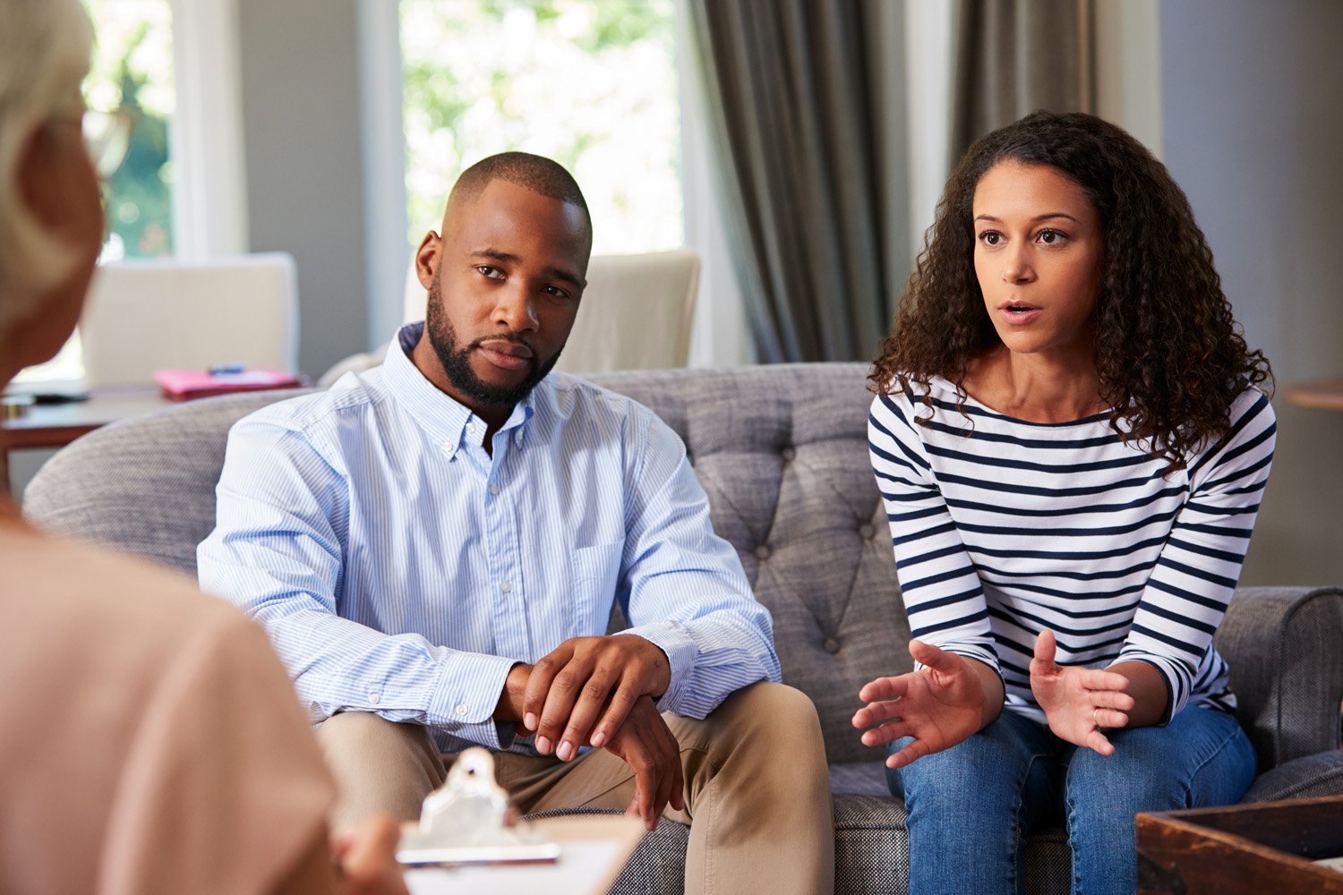 Couples therapist with clients, helping her earn 6 figures.