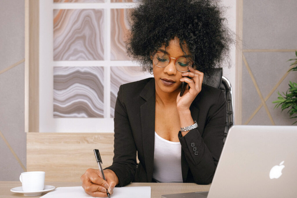 Budding sex coach sitting at table, trying to figure out math for her new business