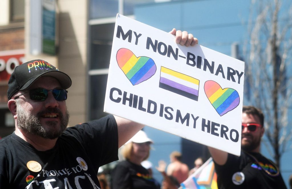 Man being nonbinary advocate at a march