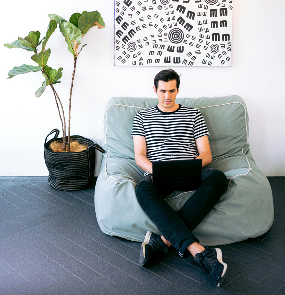 Digital nomad sex coach working on his laptop