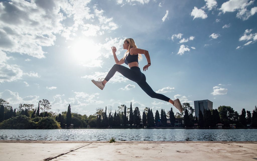Woman jumping in the air, showing she has the skills for the future of work