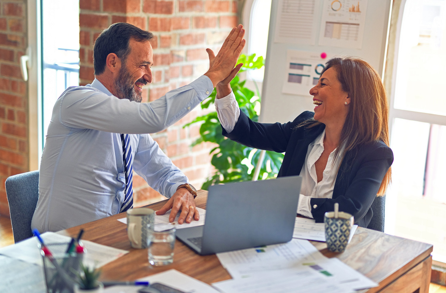 Transformational coach high-fiving his client