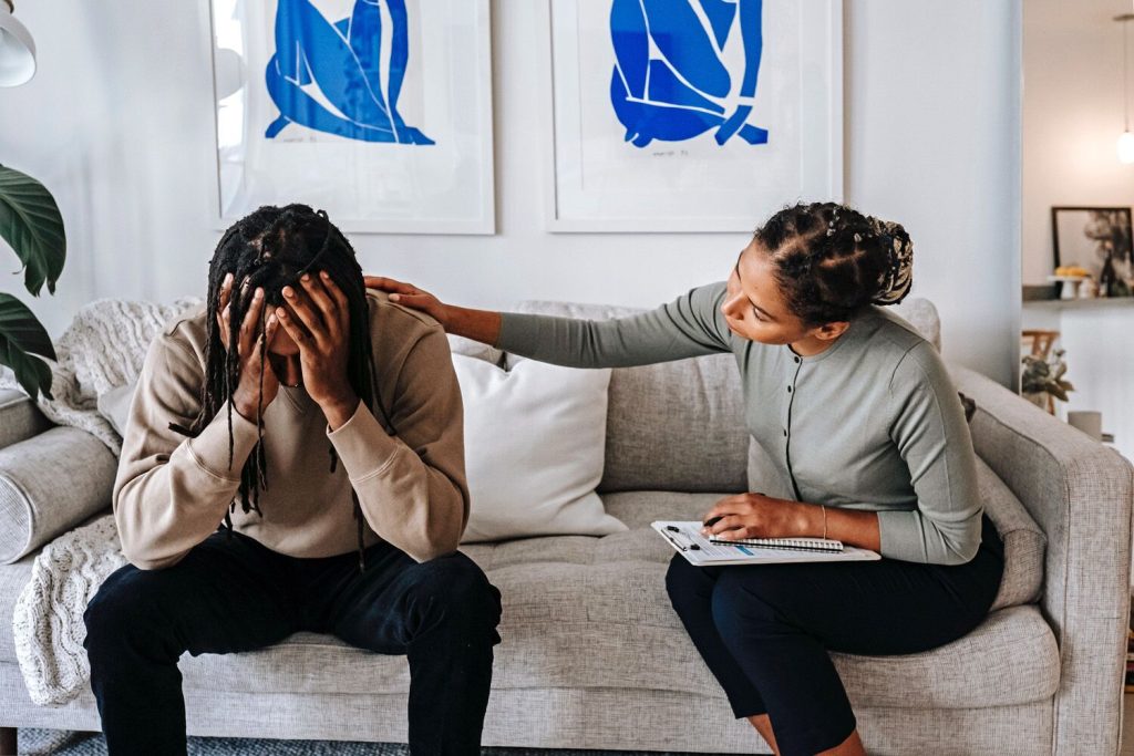 Man in session with a breakup coach
